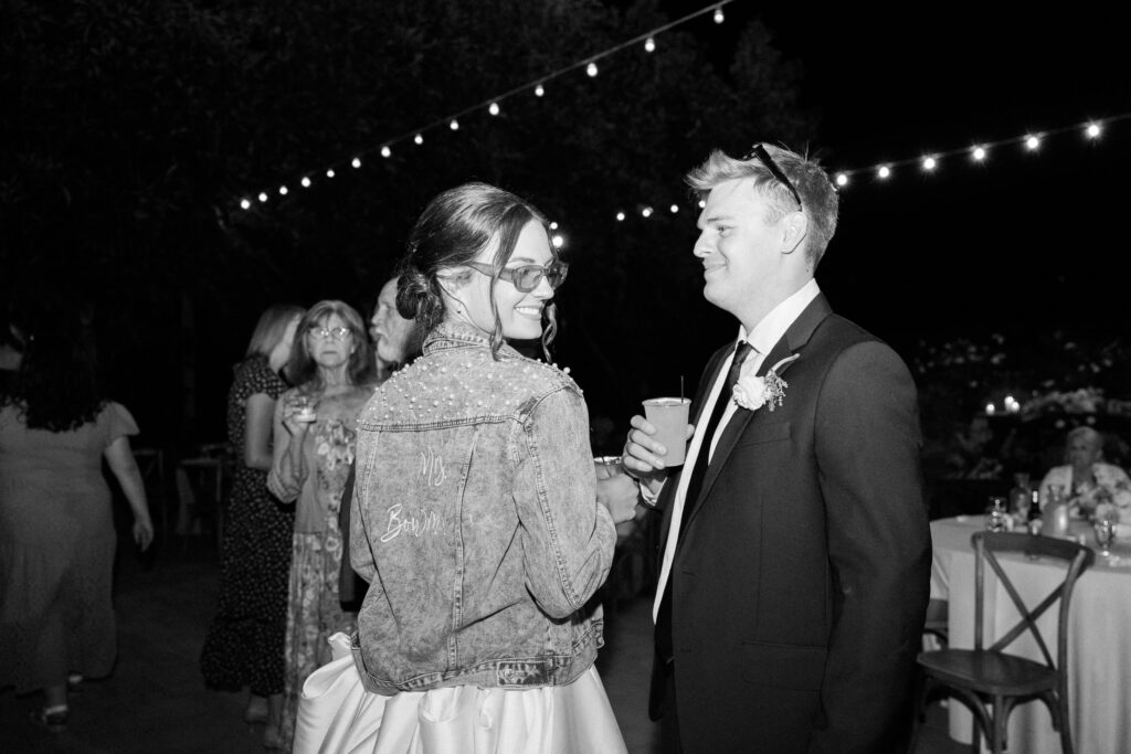 A bride in a denim jacket with 