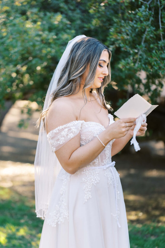 Bride reading vows during First Look at Calamigos Ranch - Lisa Leanne Photography