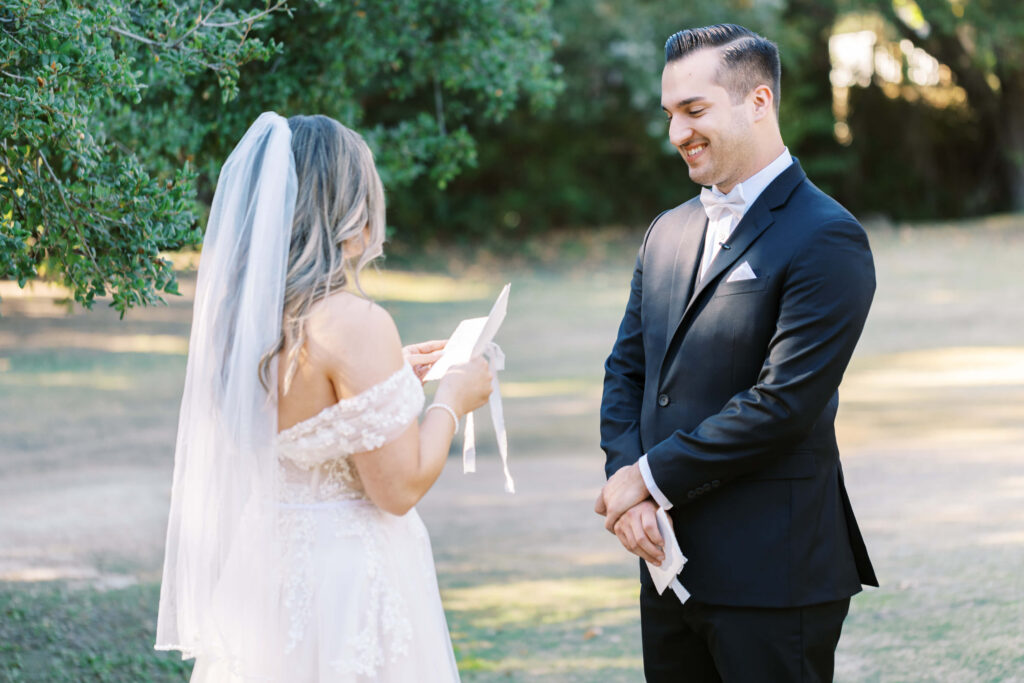 Groom smiles as Bride reads vows during First Look at Calamigos Ranch - Lisa Leanne Photography