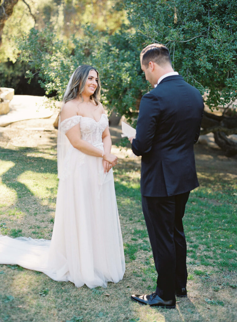 Groom reading vows during First Look at Calamigos Ranch - Lisa Leanne Photography