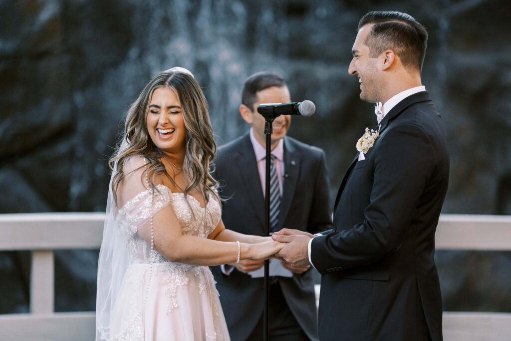 Bride and Groom laugh during their Oak Room Wedding Ceremony - Calamigos Ranch - Lisa Leanne Photography