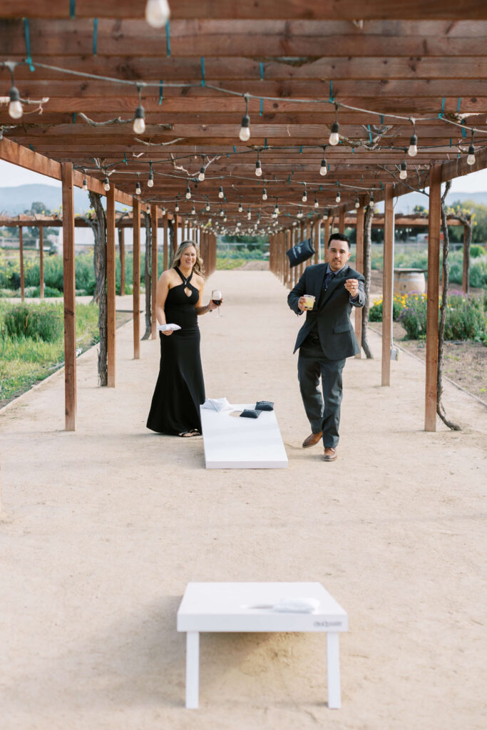 Roblar Farm Wedding Cocktail Hour Guests planing Cornhole - Lisa Leanne Photography