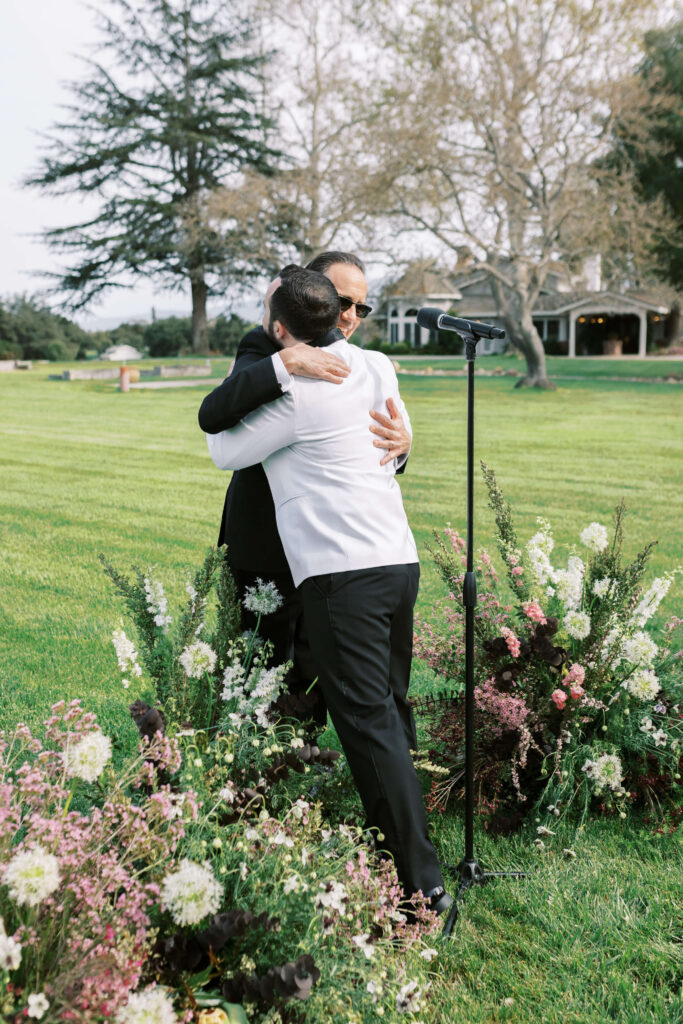 Roblar Farm Ceremony Groom hugging officiant - Lisa Leanne Photography